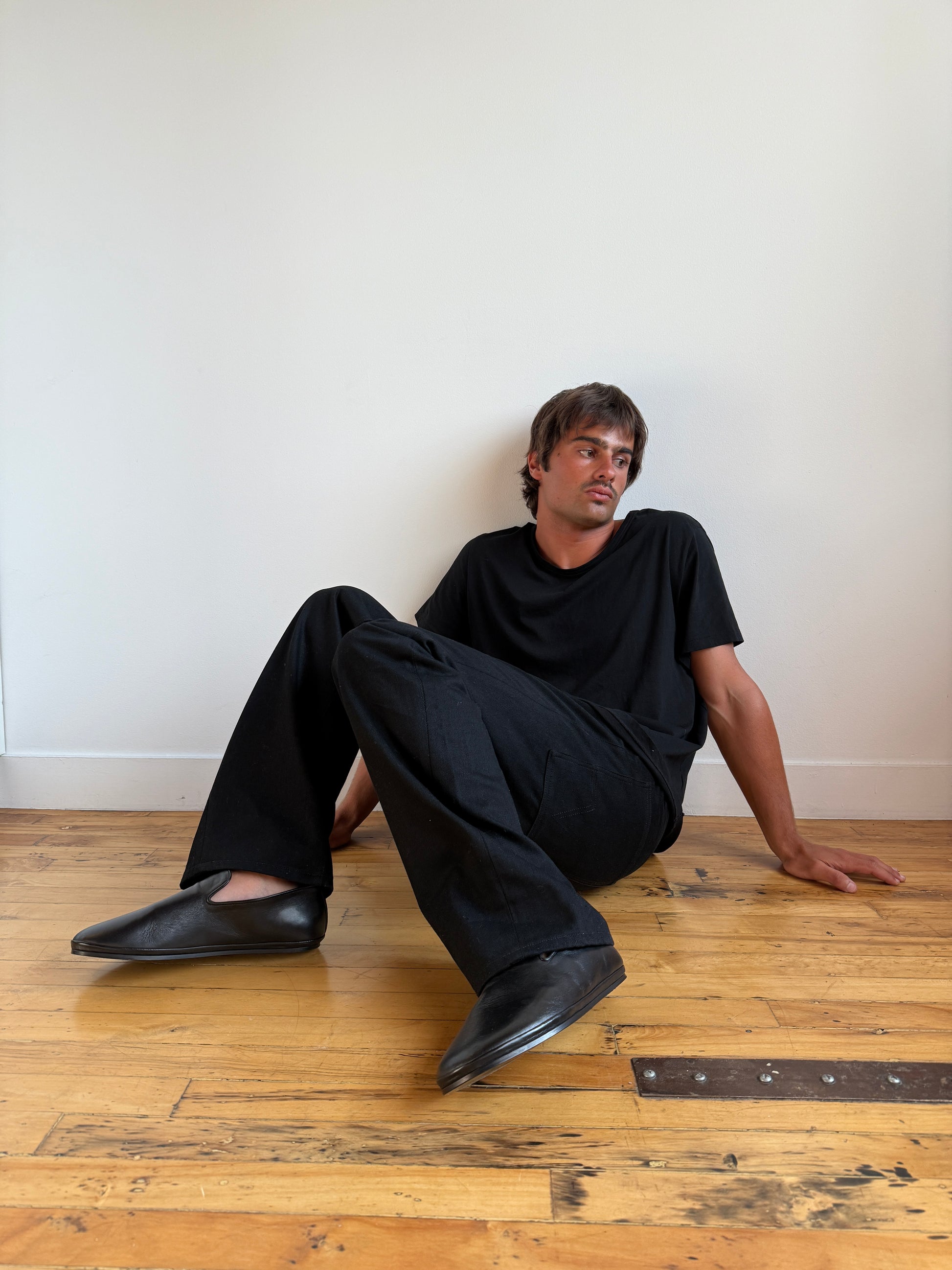 Beachwood The Glen black leather slip-on styled on model indoors with minimalist aesthetic